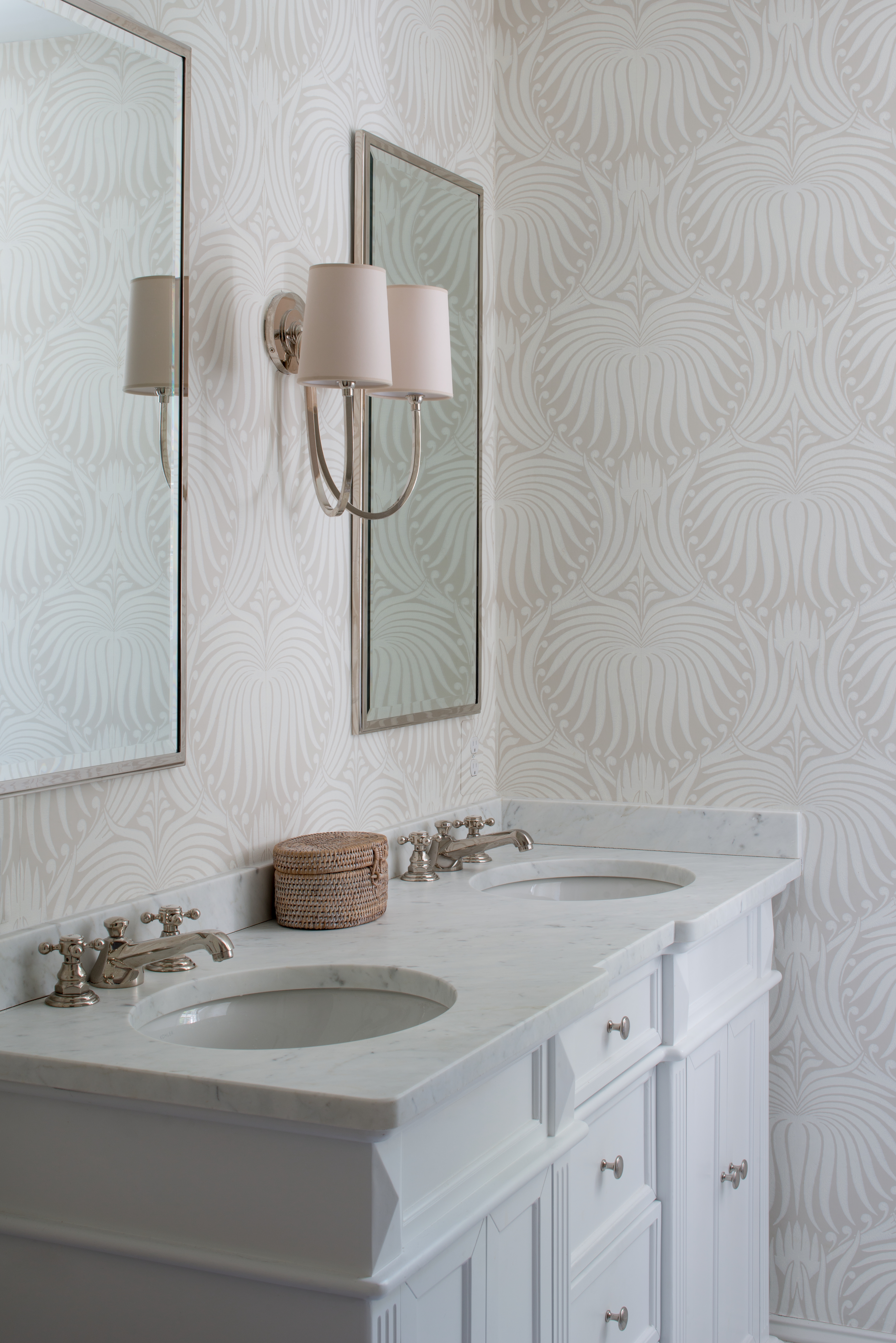 Interior designed powder room with textured wallpaper, double mirrors and a granite top vanity