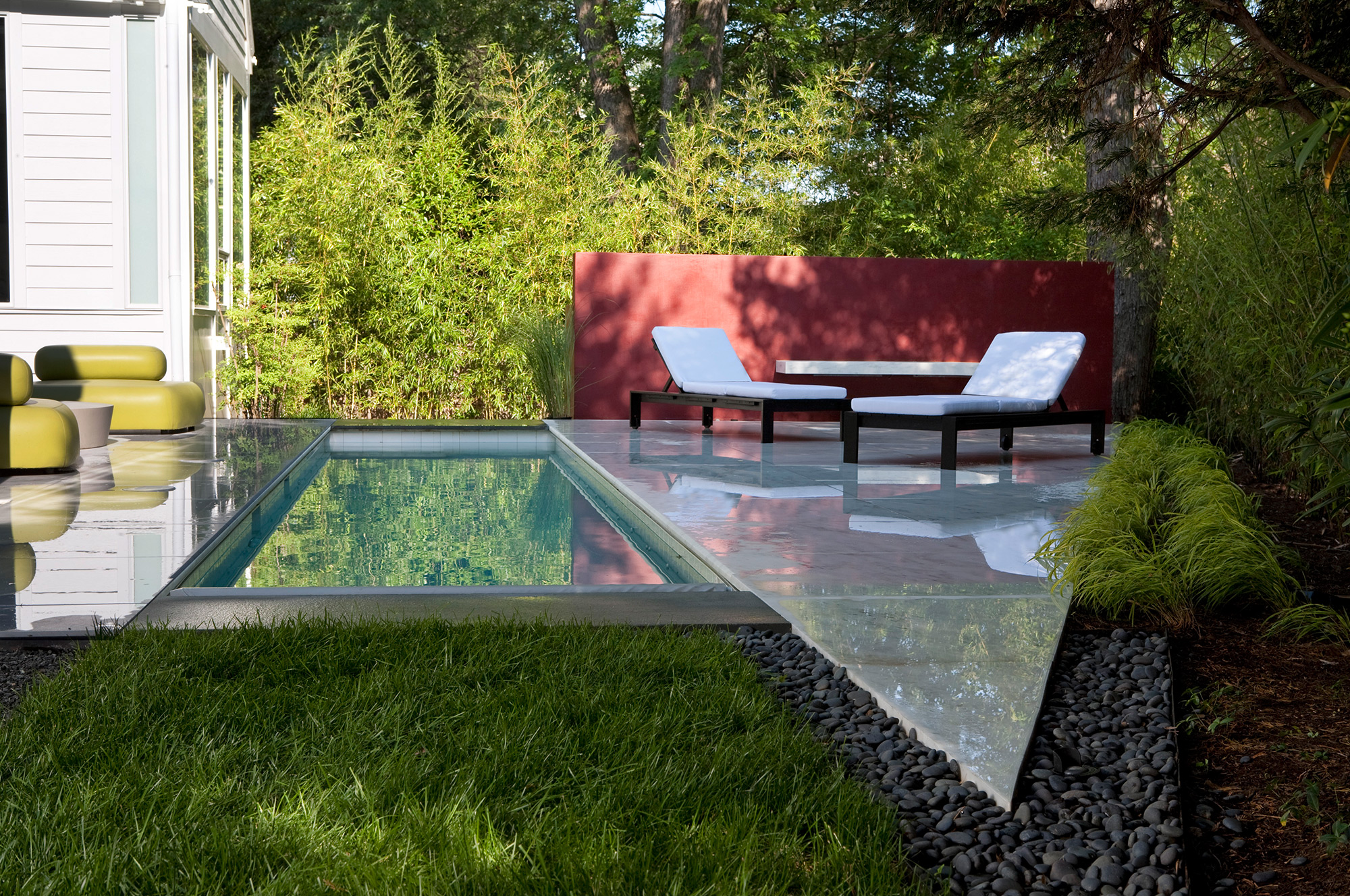 Marbled white outdoor tile surrounding a beautiful backyard pool