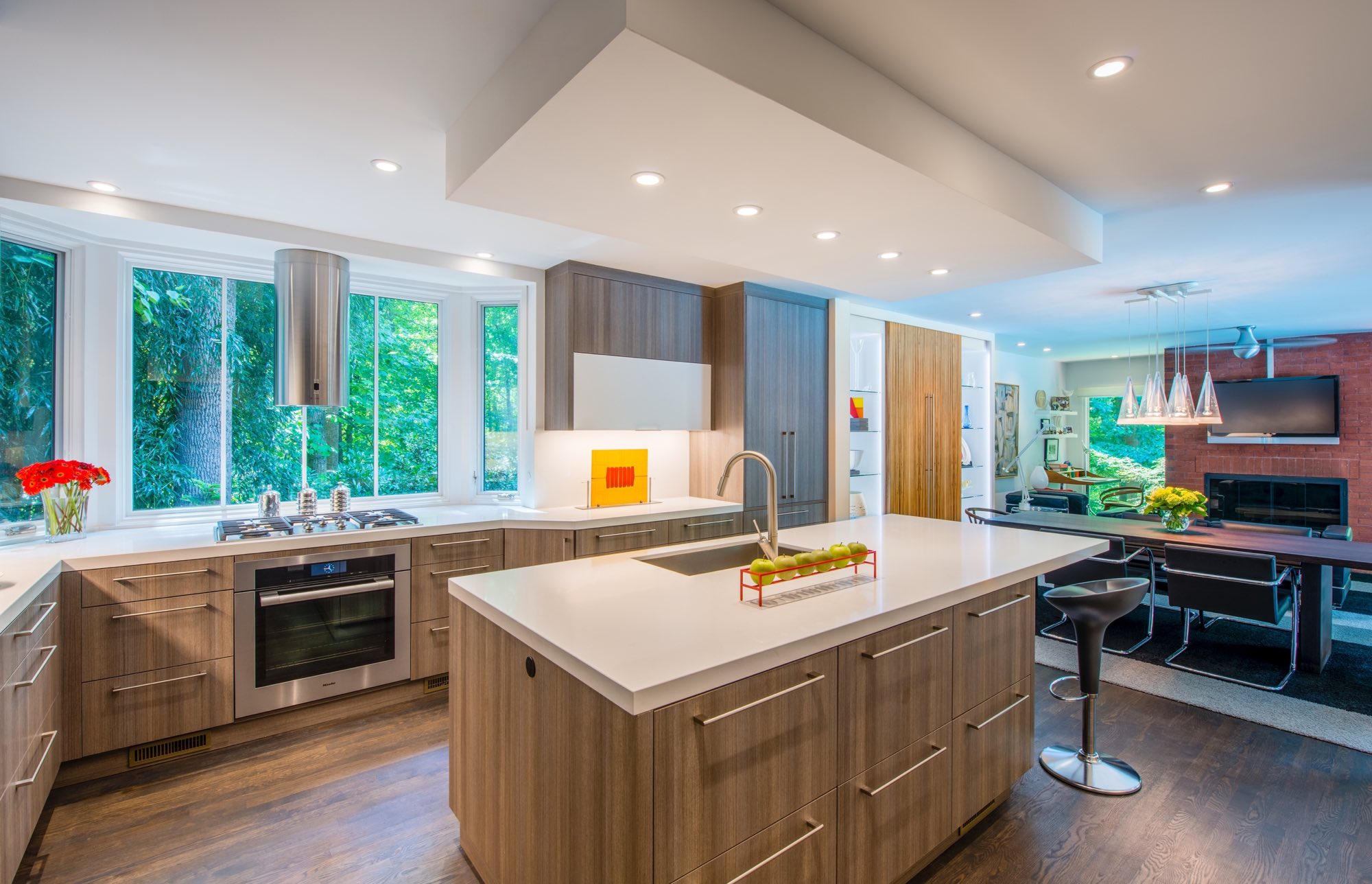 Kitchen and dining room renovation with light brown woods and white quartz counters