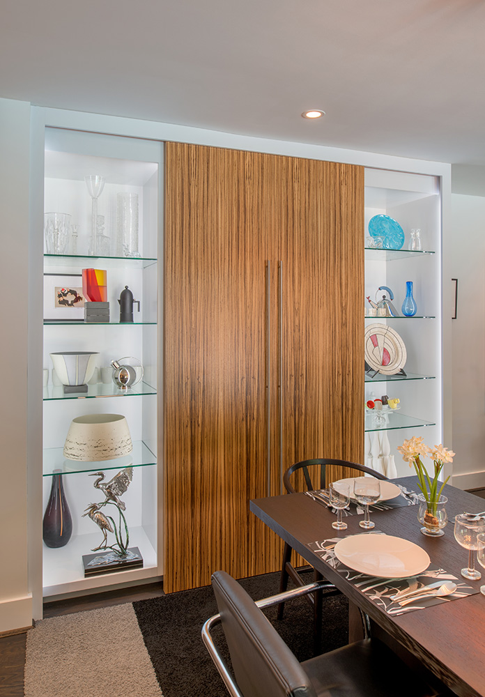 Sliding doors in striking zebrawood conceal an office niche