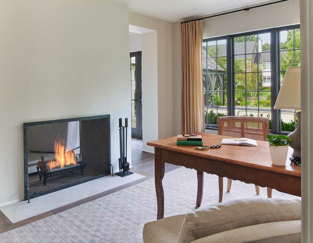 a home office with a two sided fireplace inside a bethesda maryland home remodeling project by Anthony Wilder